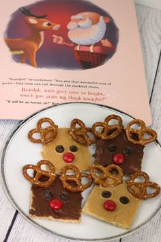 some pretzels are on a plate with santa's helper and reindeer crackers