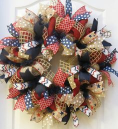 a patriotic wreath is hanging on the front door