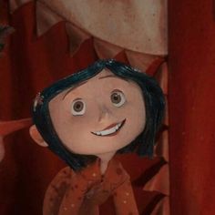 an animated doll is standing in front of a red curtain with eyes and mouth wide open