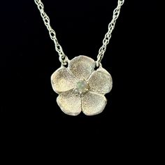 Inspired by a rare Victorian genre of jewelry , our new Forget-Me-Not Necklace is handmade in textured sterling silver with a semi-precious stone in the center. The name Forget-Me-Not comes from a German legend about a knight who died trying to obtain these flowers for his lover, calling out with his last breath, "forget me not!" They are therefore known to symbolize true love. Handcrafted in Sterling silver or 14k gold Set with one approx. 2mm stone (opal or diamond) Set on a 16" chain, fastene Silver Flower Jewelry For Memorial, Sterling Silver Flower Pendant Necklace For Memorial, Silver Flower Pendant Necklace For Memorial, Hand Forged Flower Pendant Necklace As Gift, Elegant Memorial Jewelry With Flower Charm, Nature-inspired Flower Pendant Jewelry For Anniversary, Nature-inspired Flower Gemstone Jewelry, Flower Shaped Oxidized Jewelry Gift, Flower Shaped Oxidized Jewelry As Gift