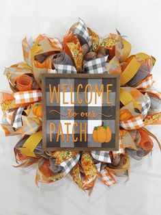 a welcome to our patch door hanger on a white background with an orange and black wreath