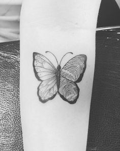 a black and white photo of a butterfly with finger prints on it's wings