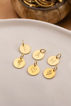 These cute 8mm gold discs are perfect add-ons to customize your necklace. Choose from birth flowers or initials to create a meaningful, personal touch. Discs come WITHOUT a chain, on 4 mm jump rings, allowing you to easily add them to your existing jewelry for a unique, personalized look. Available in 14k gold and gold-plated options. Gold Initial Pendant Necklace With Birth Flower, Elegant Charm Necklace With Birth Flower And Initial Pendant, Minimalist Birth Flower Initial Pendant Charm Necklace, Personalized Dainty Initial Pendant Charms, Gold Initials Charms For Personalized Gift, Tiny Charm, Gold Disc, Initial Necklace Gold, Monogram Jewelry