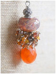 This pendant is a beautiful large Handmade Boro Glass bead made by a favorite glass artist of mine. The bead itself is almost 1" wide and 1/2" tall, and it has lovely depths to it. I added a large piece of Orange Carnelian, with more than 40 Swarovski crystals, carneilian drops and czech crystals, on a sterling silver chain, and a sterling silver lobster clasp. Necklace is approx 26 inches in length. Pendant is approximately 2 1/2" long. You'll love wearing this. I only make a few of these large Orange Carnelian, Clasp Necklace, Czech Crystal, Necklace Statement, Glass Artists, How To Make Beads, Glass Bead, Sterling Silver Pendant, Sterling Silver Chains