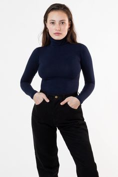 Our classic turtleneck now available in our favorite neutrals and statement bright colors to match our garment dye collection. A tight, fitted turtleneck made of high quality cotton spandex with a full fold-over turtleneck to keep you warm all season long. This top features a mid-length that can still be tucked into high waisted styles and is ideal for layering without adding bulk underneath your favorite sweaters and jackets. We recommend sizing up if you prefer a less fitted look. Please note, Brands To Shop At, Bum Outfit, Europe Shopping, Burgundy Dahlia, Classic Turtleneck, Los Angeles Apparel, Turtleneck Style, Garment Manufacturing, Fitted Turtleneck