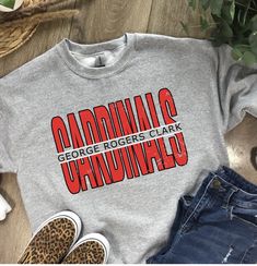 These GRC Cardinal shirts are a perfect addition to your school spirit wear!   ❗️Sizes: Toddler-2T-5T  Youth XS-XL  Adult S-XL  Adult 2X Adult 3X Available in short sleeve, long sleeve and sweatshirts!  Shirts are all unisex sizing! Shirt Color shown in Ash Gray and Sport Gray. Can do on any color, but design colors will not fully show on black or white shirts. This is a vinyl design on the shirt.  If you would like to request a custom order, please send us a message!! Team Spirit Sweatshirt With Logo Print For Game Day, Team Spirit Logo Print Sweatshirt For Game Day, School Spirit Graphic Sweatshirt For Baseball Season, School Spirit Graphic Print Sweatshirt For Baseball Season, College Logo Print Sweatshirt, Game Day Team Name Sweatshirt In Athletic Heather, Game Day Pre-shrunk Athletic Heather Tops, Collegiate Athletic Heather Tops For Game Day, Game Day Tops In Athletic Heather