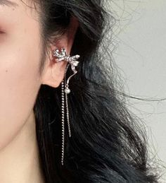 Sparkling no piercing silver ribbon ear cuff climber, with pearl and rhinestone dangles. Stylish punk street wear style, super chic and edgy. No ear hole necessary, easy to wear and adjust. Delicate cubic zircon paved on cute silver ribbon. Absolutely unique add on to your everyday outfit! , 💎 Features: ♥ Material: Silver plated copper ♥ Main stone: Faux pearl ♥ Side Stone: Rhinestone ♥ Adjustable ear cuff, no ear hole needed ♥ Sold as 1 piece 💎 Details: ♥ Approximate Measurements: - Length: 7.5 cm - Width: 2.3 cm ♥ Lightweight, easy to wear ♥ Nickel/Lead Free, Hypoallergenic, good for sensitive skins 🎁 Packing & Shipping: ♥ All our jewelry will be shipped with beautiful gift wrap packaging ♥ Handwrite gift notes/cards available upon request ♥ SAME DAY& FREE US Domestic Shipping availab Pearl Ear Cuff, Street Wear Style, Ribbon Earrings, Handwritten Gifts, Tassel Earing, Silver Ribbon, Beautiful Gift Wrapping, Everyday Outfit, Cuff Earrings