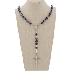 This Murano Glass Rosary Necklace features beautiful blue Millefiori beads and a silver-plated crucifix handcrafted by the skilled master glass-makers in a family-owned workshop on Murano island in Venice, Italy. The rosary necklace is created by hand using ancient glass-making tools and techniques. This is a beautiful religious gift with an Italian flair that will be uniquely appropriate for a special occasion. Measurements: Full Length is 27 inches. The length from the centerpiece to the botto Venice Glass, Millefiori Beads, Murano Glass Jewelry, Glass Making, The Rosary, Rosary Necklace, Murano Glass Beads, Venetian Glass, Making Tools