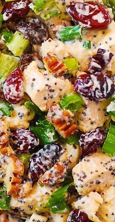 a salad with chicken, broccoli and cranberries is shown close up