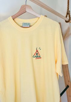 We sell primarily on our website and offer free shipping options + hats. TwinRavenCo Prepare for a summer full of adventures in our comfy retro cabin crew tee. 𓄿 Garment Dyed- giving that perfect vintage look that will remain for the life of the T-shirt 𓄿 Relaxed fit 𓄿 Topstitched, classic width, rib collar 𓄿 Twill taped neck and shoulders 𓄿 Pre-Shrunk 𓄿 Unisex Sizing.  Embroidery stabilizer is applied to the back of every professionally embroidered item and is never to be removed. This is Summer Outdoor Cotton T-shirt, Summer Camping T-shirt With Crew Neck, Summer Adventure T-shirt With Short Sleeves, Summer Camping Crew Neck T-shirt, Summer Camping Tops With Letter Print, Summer Camping Top With Letter Print, Screen Print T-shirt For Summer Outdoor, Summer Crew Neck T-shirt For Outdoor Activities, Summer Graphic Tee For Camping