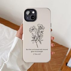 a person holding up a phone case with a flower on the back that says, but the lord stood with me and gave strength