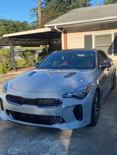 a silver car parked in front of a house