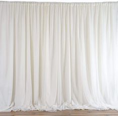 a white curtain is hanging on the wall