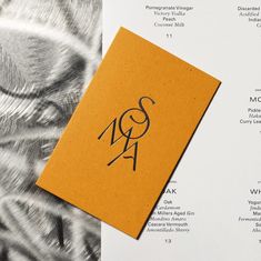 a menu with an orange and black design on it