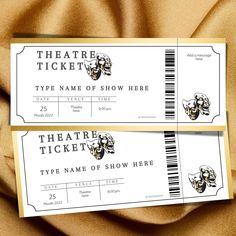 two tickets with skull heads on them are sitting on a gold satin background, one has a ticket for the theatre show