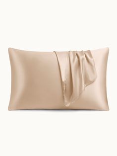 a pillow with a satin bow on the front and back of it, against a white background