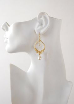 These beautiful bridal earrings are made with matte gold plated pendants and Swarovski round and teardrop cream pearls. The matte gold pendant has beautifully textured dot design. Total length of these earrings is approx. 2.5 inches (64mm). The pearls can be changed to a different color upon request. ♥ Click the link below to see more beautiful modern earrings: www.etsy.com/shop/LeChaim?section_id=17655958 ♥Thank you for stopping by. Please contact me if you have any questions or need a differen Gold Chandelier Earrings With Pearl Charm For Party, Pearl White Chandelier Earrings With Pearl Drop For Anniversary, Pearl White Pearl Drop Chandelier Earrings For Anniversary, Pearl White Chandelier Earrings For Anniversary, Teardrop Pearl Drop Chandelier Earrings For Party, Elegant Teardrop Pearl Earrings With Dangling Beads, Formal Gold Chandelier Earrings With Pearl Charm, Pearl Teardrop Chandelier Earrings For Pierced Ears, Pearl White Teardrop Chandelier Earrings For Wedding