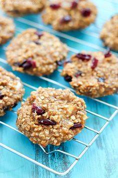 oatmeal cookies with cranberries are cooling on a metal wire rack