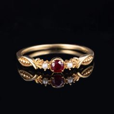 At our establishment, we take pride in guaranteeing the authenticity of every gemstone. Each piece of jewelry features natural stones sourced from the world's most renowned regions. Our rubies are procured from Mozambique and Sri Lanka, while our sapphires are exclusively from Sri Lanka. Our emeralds are sourced from Zambia and Colombia, with tourmalines and amethysts originating from Brazil. Additionally, our opals are from Australia and Ethiopia. Rest assured, all our gold is of the highest ca Elegant Round Ruby Promise Ring, Classic Ruby Ring With Gemstone Accents For Promise, Fine Jewelry Pearl Ring With Birthstone For Anniversary, Gold Ruby Ring With Gemstone Accents For Anniversary, Elegant Ruby Promise Ring With Round Stone, Ruby Jewelry With Prong Setting For Promise, Exquisite Ruby Ring With Gemstone Accents For Anniversary, Round Ruby Ring With Gemstone Accents, Ruby Ring With Diamond Accents