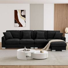 a modern living room with black couch and white coffee table