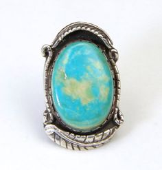 - Wonderful southwestern style artisan ring with huge single turquoise stone- Turquoise stone is surrounded by beautiful sterling silver work, including leaf detail- Natural Turquoise stone is green-blue color with light caramel matrix- There are two surface hairline cracks in turquoise but the stone is still viable and sturdy in bezel- Turquoise stone measures 30mm tall by 21mm wide- Ring is signed "WH"- Ring face measures 1.74" tall by 1.05" wide and .31" deep- Ring is a size 8- Ring weighs 19 Italian Gold Jewelry, Silver Turquoise Jewelry, Natural Turquoise Stone, Druzy Jewelry, Metal Clay Jewelry, Artisan Rings, Silver Work, Turquoise Rings, Southwestern Style