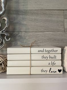 three books are stacked on top of each other with the words and together they built a life they love