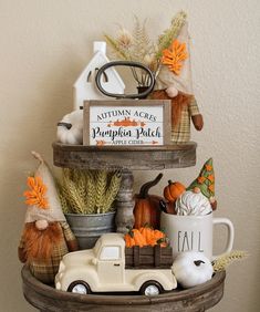 a shelf filled with pumpkins and fall decorations