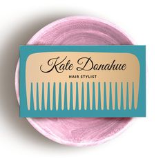 the label for kate donaue hair stylist is shown on a pink plate