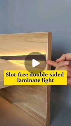 a person is holding a piece of wood with a light on it and the text, slot - free double - sided laminate light