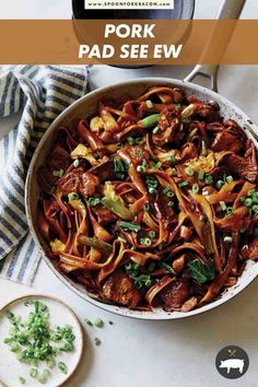 a pan filled with meat and vegetables on top of a table