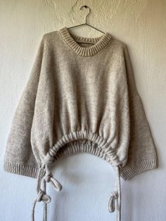 a sweater hanging up on a wall