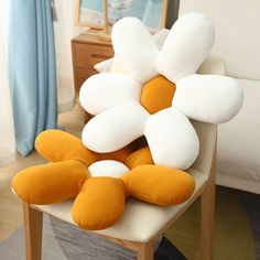 a bunch of pillows sitting on top of a chair