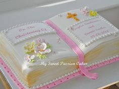 a cake decorated with an open bible and flowers