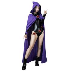 a woman in a purple cape and black bodysuit is posing for the camera with her finger up