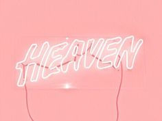 a neon sign with the word heaven on it's side in front of a pink background