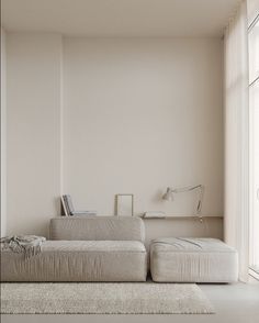 a living room with a large white couch next to a window