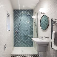 a bathroom with a shower, sink and mirror