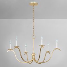 a gold chandelier with five candles hanging from it