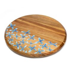 a wooden cutting board with blue flowers on it