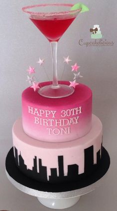 a pink and black cake with a martini on top