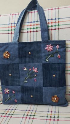 a blue tote bag with flowers on it