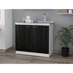 a white sink sitting next to a wooden cabinet in a room with grey walls and wood flooring