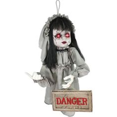 a creepy doll holding a sign that says danger on the front and back with red eyes