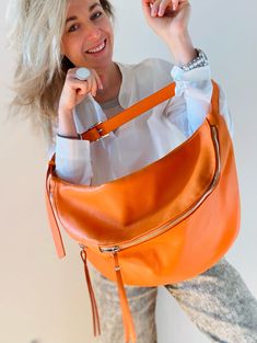 Unusual sporty and elegant at the same time ;-) Great sling bag made of genuine leather in a beautiful bright orange. Great for every day. The adjustable shoulder strap is also made of genuine leather. It will feel very comfortable when worn. This shoulder bag consists of two compartments with high-quality zippers and an inner pocket with zipper. The measures are: H=25 and D=50 cm. Leather Bum Bag, Pack Bag, Leather Sling Bag, Orange Top, Orange Bag, Bum Bag, Bag Shoulder, Bright Orange, Sling Bag