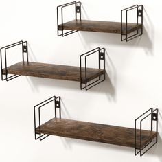 three metal and wood shelves on the wall with one shelf holding two bookshelves