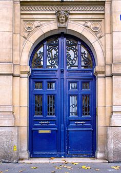 an ornate blue door on the side of a building