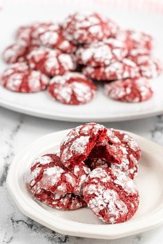 red velvet crinkle cookies on a plate with powdered sugar in the middle