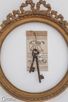 an old key hangs on the wall in a frame