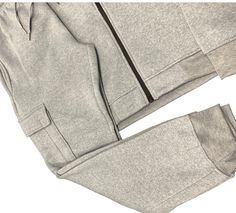 Upgrade your workout wardrobe with our Men Fleece Jogger Outfit. Stay warm and cozy in the soft fleece material. Featuring utility cargo pockets, perfect for storing essentials during your workout. Complete the set with our matching sweat jacket. Get the ultimate comfort and convenience with this sweatpants and jacket combo. About this item1.Matching 2-piece Fleece jogging suit with jogger sweatpants and fleece sweat jacket2.Sweatpants with cargo pockets on both sides, 2 side pockets and a back Functional Fleece Outerwear For Loungewear, Winter Streetwear Activewear With Pockets, Hooded Sports Sweats With Pockets, Hooded Sweats With Pockets For Sports, Sportswear Sweats With Pockets, Fall Activewear With Side Pockets For Streetwear, Urban Winter Activewear With Pockets, Winter Athleisure Sweats With Pockets, Fall Athleisure Tracksuit With Side Pockets