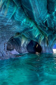 the water is crystal blue and it looks like they are floating in an ice cave